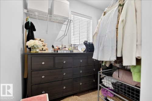 Walk in closet featuring light carpet - 6609 47 Avenue, Beaumont, AB - Indoor