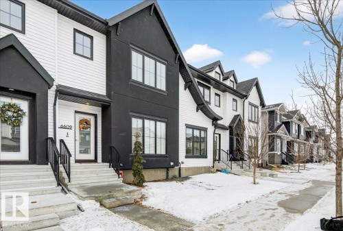 Modern inspired farmhouse featuring a residential view and stucco siding - 6609 47 Avenue, Beaumont, AB - Outdoor With Facade
