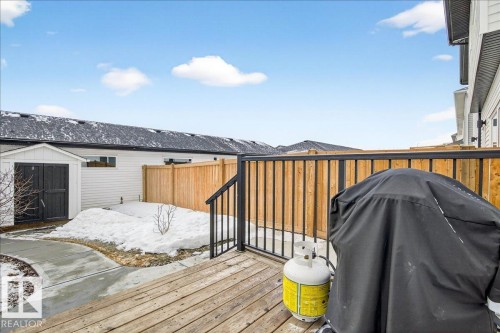 Wooden terrace featuring a fenced backyard, a storage shed, and grilling area - 6609 47 Avenue, Beaumont, AB - Outdoor With Exterior