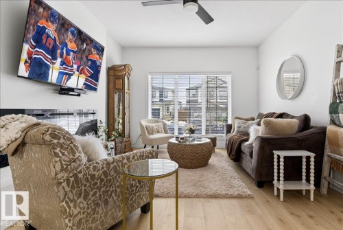 Sitting room featuring light wood-style flooring and a ceiling fan - 6609 47 Avenue, Beaumont, AB - Indoor Photo Showing Living Room