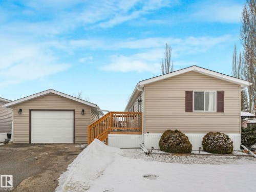 View of snow covered exterior with a garage and driveway - 151 3400 48 Street, Stony Plain, AB - Outdoor With Exterior