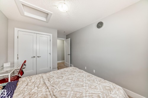 Bedroom with attic access, a textured ceiling, and a closet - 41 4835 Wright Drive, Edmonton, AB - Indoor Photo Showing Bedroom