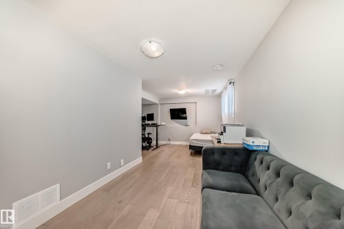 Living room featuring light wood-style floors and an office area - 41 4835 Wright Drive, Edmonton, AB - Indoor