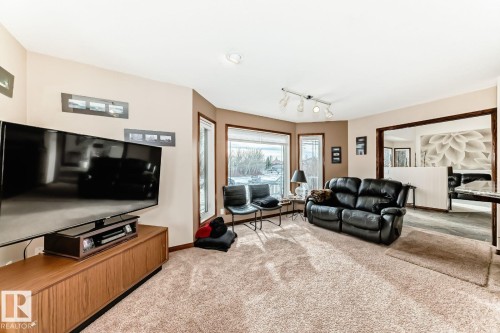 Living area with track lighting and light colored carpet - 777 Butterworth Drive, Edmonton, AB - Indoor Photo Showing Living Room