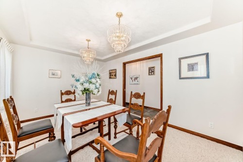 Dining room featuring a tray ceiling and a chandelier - 777 Butterworth Drive, Edmonton, AB - Indoor Photo Showing Dining Room