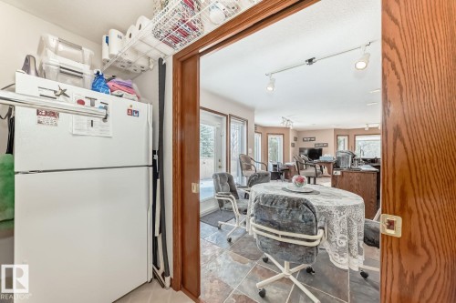 Dining area with track lighting, plenty of natural light, and light tile patterned flooring - 777 Butterworth Drive, Edmonton, AB - Indoor