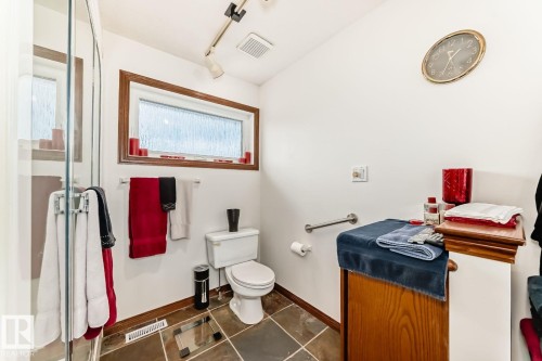Full bath featuring a stall shower and dark tile patterned floors - 777 Butterworth Drive, Edmonton, AB - Indoor Photo Showing Bathroom