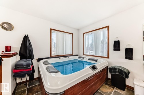 Miscellaneous room featuring a hot tub and baseboards - 777 Butterworth Drive, Edmonton, AB - Indoor Photo Showing Other Room