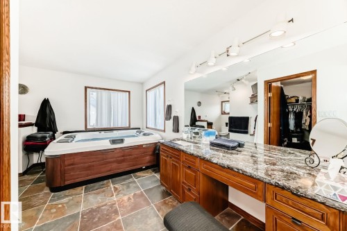 Full bathroom with a garden tub, vanity, a walk in closet, and rail lighting - 777 Butterworth Drive, Edmonton, AB - Indoor Photo Showing Bathroom