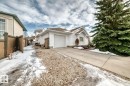 View of front of property featuring an attached garage, a chimney, and concrete driveway - 777 Butterworth Drive, Edmonton, AB  - Outdoor 
