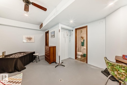 Bedroom featuring concrete floors, a ceiling fan, a closet, and ensuite bathroom - 777 Butterworth Drive, Edmonton, AB - Indoor