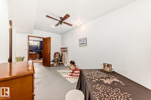 Playroom featuring concrete flooring, a ceiling fan, and a desk - 777 Butterworth Drive, Edmonton, AB - Indoor