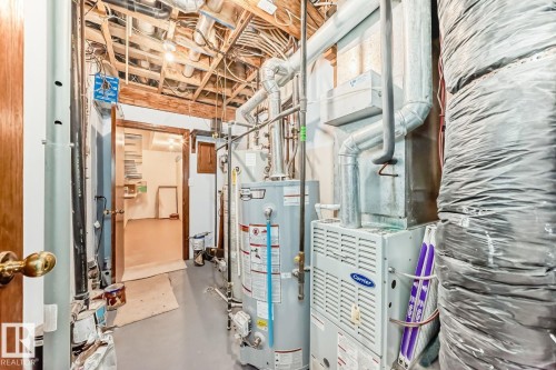 Utilities featuring water heater and heating unit - 777 Butterworth Drive, Edmonton, AB - Indoor Photo Showing Basement