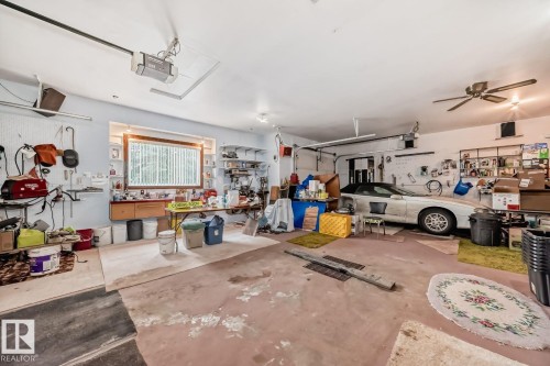 Garage featuring a workshop area and a garage door opener - 777 Butterworth Drive, Edmonton, AB - Indoor Photo Showing Garage