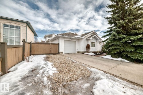 Ranch-style home featuring an attached garage, driveway, and a gate - 777 Butterworth Drive, Edmonton, AB - Outdoor