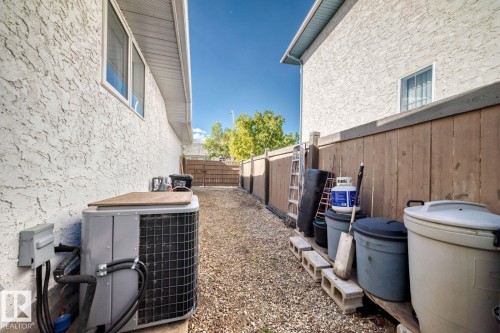View of property exterior with stucco siding and a fenced backyard - 777 Butterworth Drive, Edmonton, AB - Outdoor With Exterior
