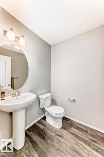 Bathroom with wood finished floors and toilet - 2823 Duke Crescent, Edmonton, AB - Indoor Photo Showing Bathroom