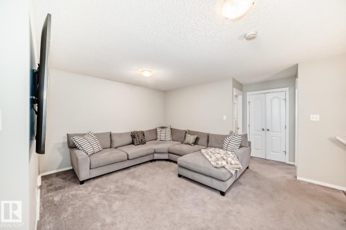 Living area featuring carpet floors and a textured ceiling - 2823 Duke Crescent, Edmonton, AB - Indoor Photo Showing Living Room