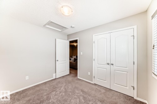 Unfurnished bedroom featuring carpet, a closet, and a textured ceiling - 2823 Duke Crescent, Edmonton, AB - Indoor Photo Showing Other Room