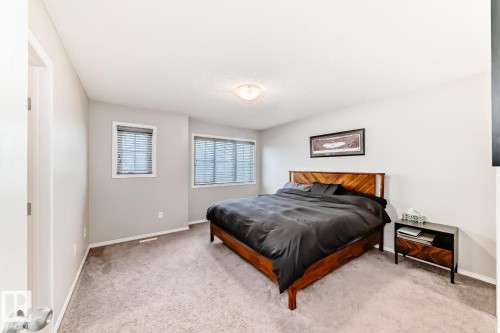 Bedroom featuring light carpet and baseboards - 2823 Duke Crescent, Edmonton, AB - Indoor Photo Showing Bedroom
