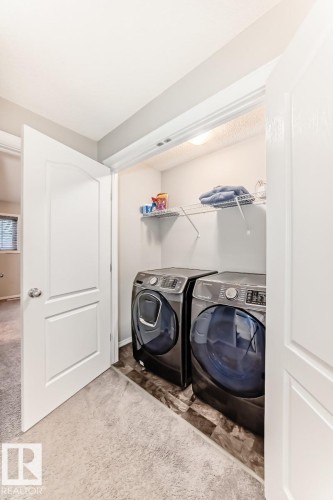 Laundry area with carpet flooring and washing machine and dryer - 2823 Duke Crescent, Edmonton, AB - Indoor Photo Showing Laundry Room