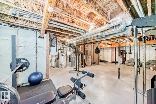 Exercise room featuring concrete flooring and gas water heater - 2823 Duke Crescent, Edmonton, AB - Indoor Photo Showing Other Room