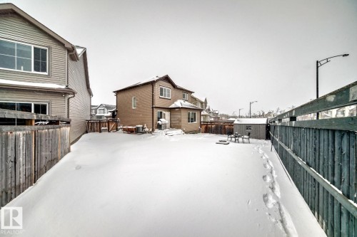 Snow covered house with a residential view and a fenced backyard - 2823 Duke Crescent, Edmonton, AB - Outdoor With Exterior