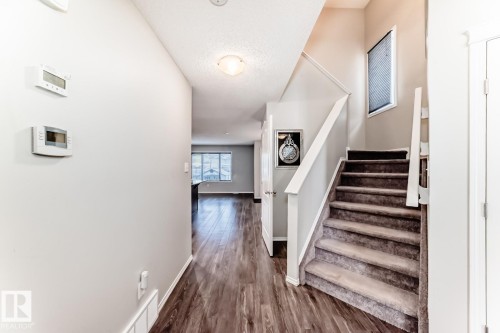 Stairway with wood finished floors and a textured ceiling - 2823 Duke Crescent, Edmonton, AB - Indoor Photo Showing Other Room