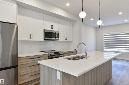 8311 & 8313 76 Avenue, Edmonton, AB - Indoor Photo Showing Kitchen With Double Sink With Upgraded Kitchen