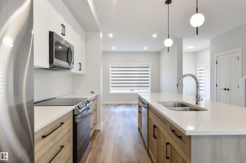 8311 & 8313 76 Avenue, Edmonton, AB - Indoor Photo Showing Kitchen With Double Sink With Upgraded Kitchen
