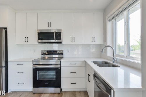 8311 & 8313 76 Avenue, Edmonton, AB - Indoor Photo Showing Kitchen With Double Sink