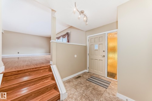 Foyer entrance with baseboards and light tile patterned flooring - 38 Lancaster Crescent, St. Albert, AB - Indoor Photo Showing Other Room