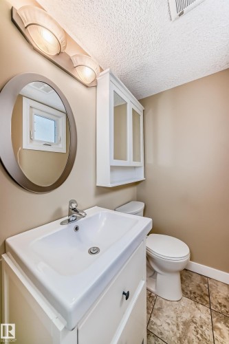 Half bathroom featuring vanity and a textured ceiling - 38 Lancaster Crescent, St. Albert, AB - Indoor Photo Showing Bathroom