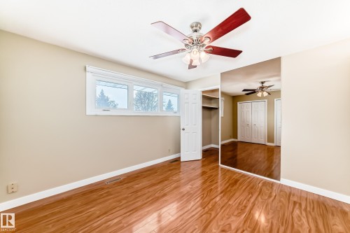 Unfurnished bedroom featuring wood finished floors and ceiling fan - 38 Lancaster Crescent, St. Albert, AB - Indoor Photo Showing Other Room