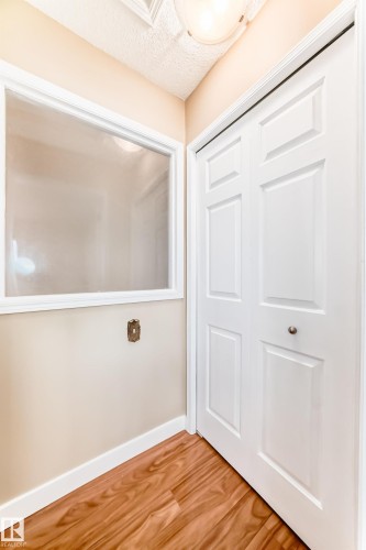 Doorway featuring a textured ceiling and wood finished floors - 38 Lancaster Crescent, St. Albert, AB - Indoor Photo Showing Other Room