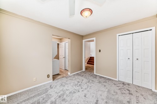Unfurnished bedroom with crown molding, light colored carpet, and a closet - 38 Lancaster Crescent, St. Albert, AB - Indoor