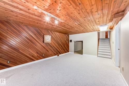 Additional living space with wood walls, carpet, and wood ceiling - 38 Lancaster Crescent, St. Albert, AB - Indoor Photo Showing Other Room