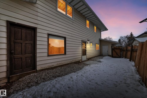 Back of property at dusk featuring a gate and a fenced backyard - 38 Lancaster Crescent, St. Albert, AB - Outdoor With Exterior