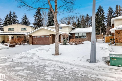 View of front of property featuring brick siding and an attached garage - 38 Lancaster Crescent, St. Albert, AB - Outdoor