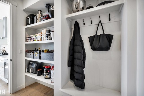 Mudroom with light wood-style floors and beverage cooler - 11 Promenade Point(E), Beaumont, AB - Indoor