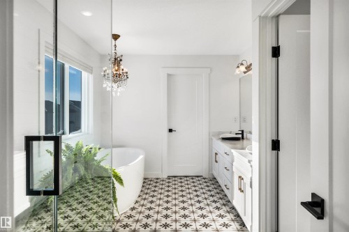 Full bathroom with a freestanding tub, double vanity, and suspended lighting - 11 Promenade Point(E), Beaumont, AB - Indoor Photo Showing Bathroom
