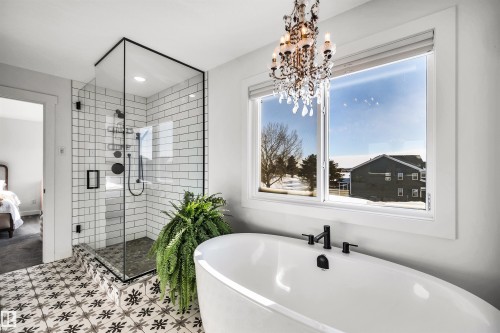 Bathroom with a shower stall, a freestanding bath, and ensuite bath - 11 Promenade Point(E), Beaumont, AB - Indoor Photo Showing Bathroom