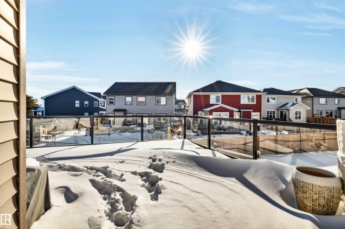 Snowy yard with a residential view - 11 Promenade Point(E), Beaumont, AB - Outdoor With Deck Patio Veranda
