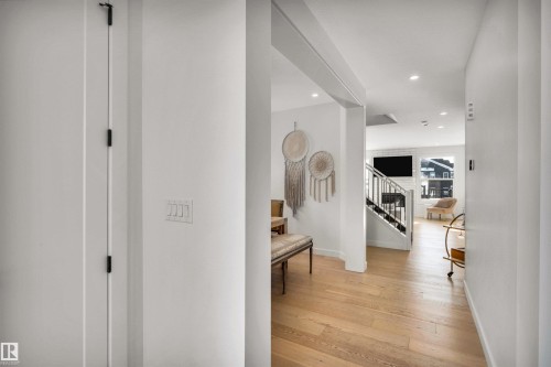 Hallway featuring light wood-type flooring and recessed lighting - 11 Promenade Point(E), Beaumont, AB - Indoor Photo Showing Other Room
