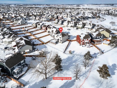 Snowy aerial view featuring a residential view - 11 Promenade Point(E), Beaumont, AB - Outdoor With View