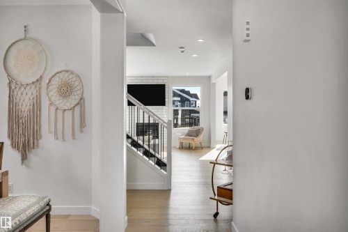 Hall featuring light wood-type flooring and recessed lighting - 11 Promenade Point(E), Beaumont, AB - Indoor Photo Showing Other Room