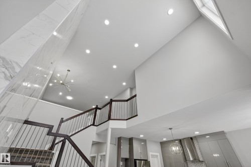 Stairway featuring a chandelier and a high ceiling - 3224 160 Street, Edmonton, AB - Indoor Photo Showing Other Room