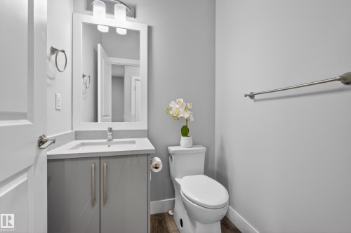 Half bathroom with vanity and dark wood finished floors - 3224 160 Street, Edmonton, AB - Indoor Photo Showing Bathroom