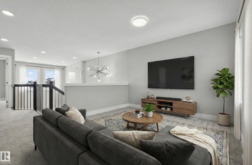 Carpeted living room with a chandelier and baseboards - 3224 160 Street, Edmonton, AB - Indoor Photo Showing Living Room