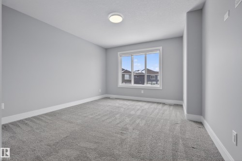 Empty room featuring light colored carpet and baseboards - 3224 160 Street, Edmonton, AB - Indoor Photo Showing Other Room
